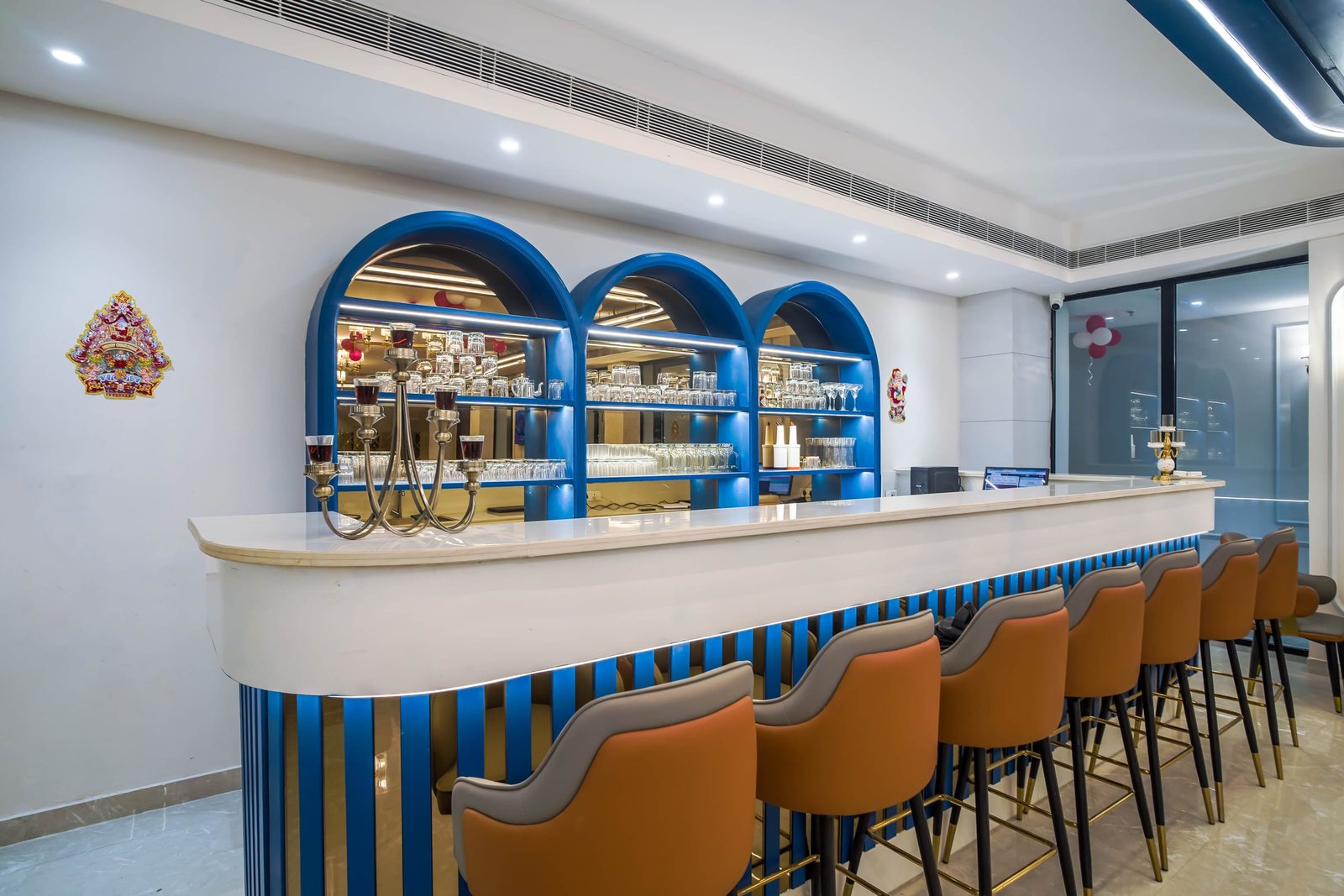 The bar at Club House, bottles behind blue arches