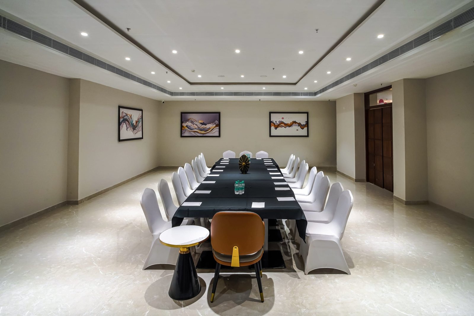 The boardroom table set for a full sitting