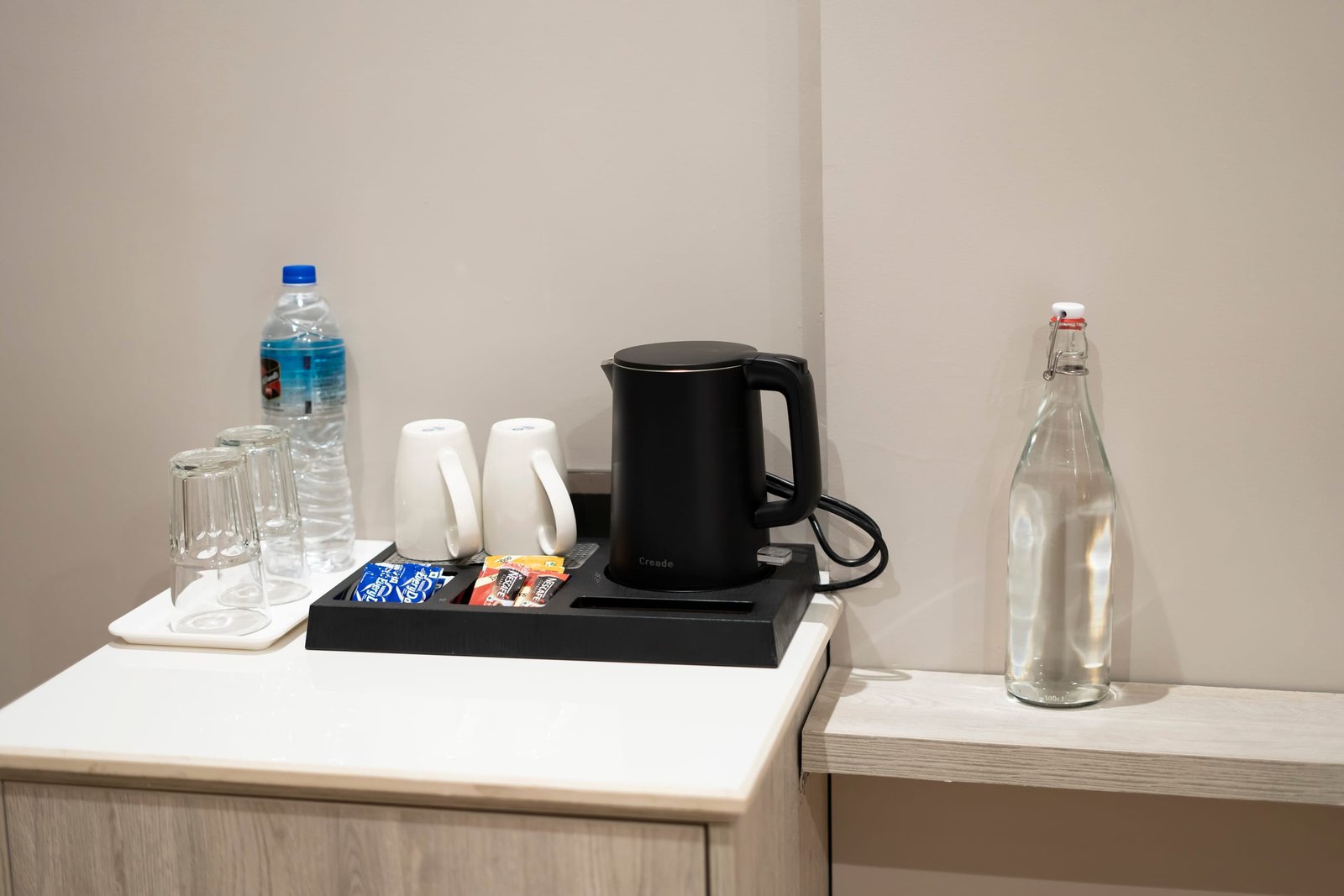 Tea and coffee tray with kettle and bottled water