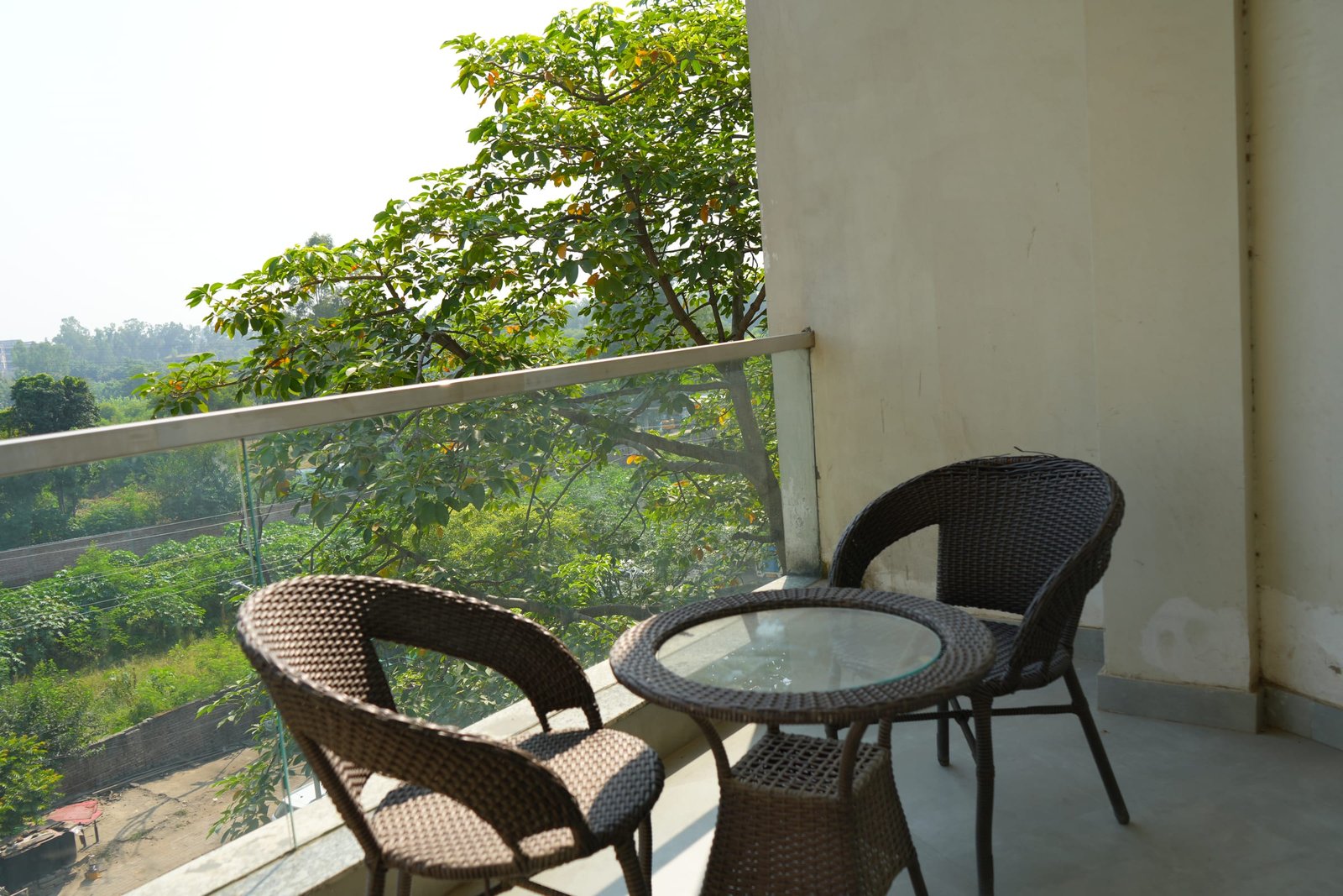 A balcony on an upper floor looking out over trees