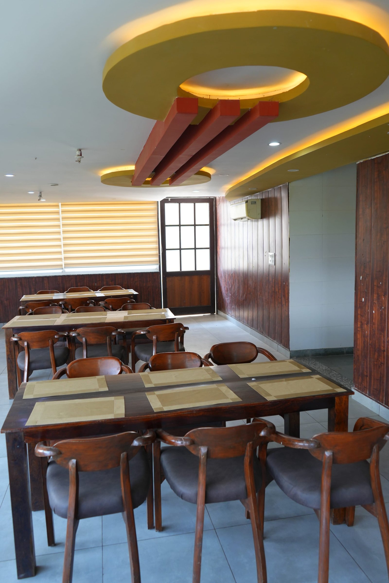 The dining room, tables laid along the window