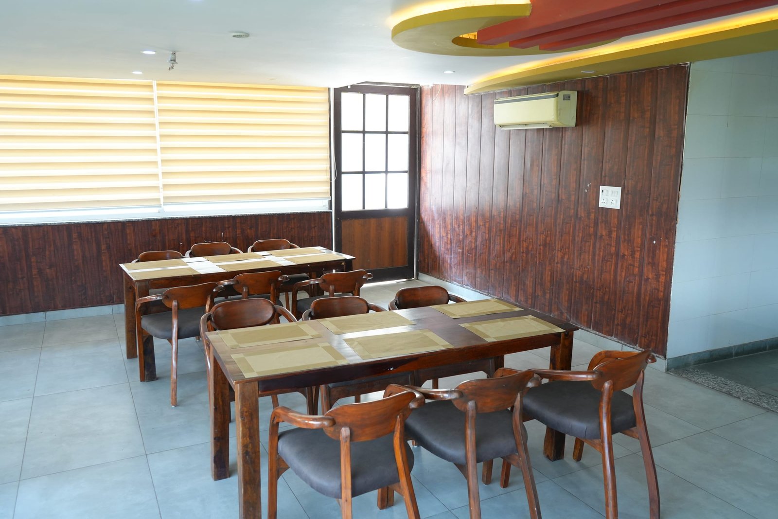 Wooden tables and chairs across the dining room