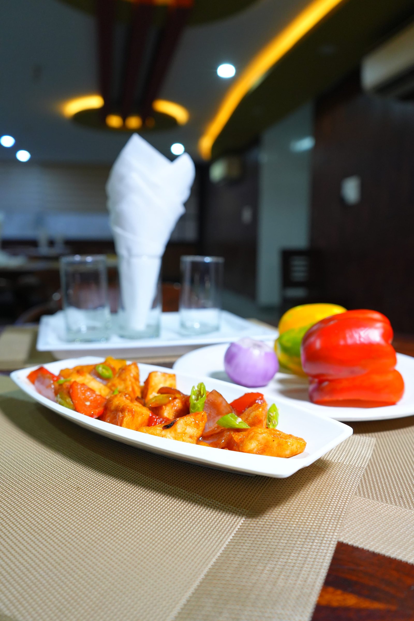 Paneer tikka plated with peppers