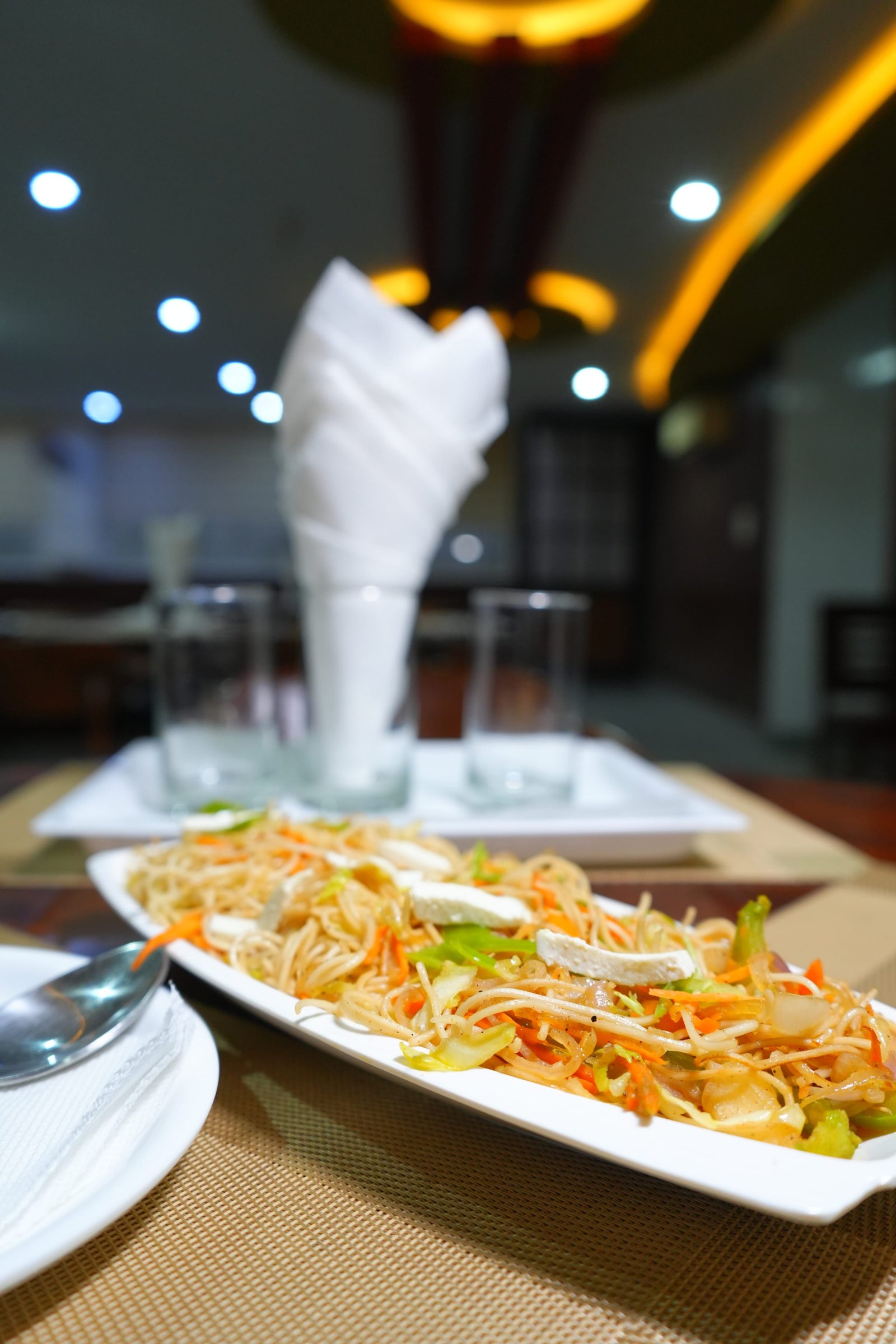 Stir-fried noodles served with a garnish