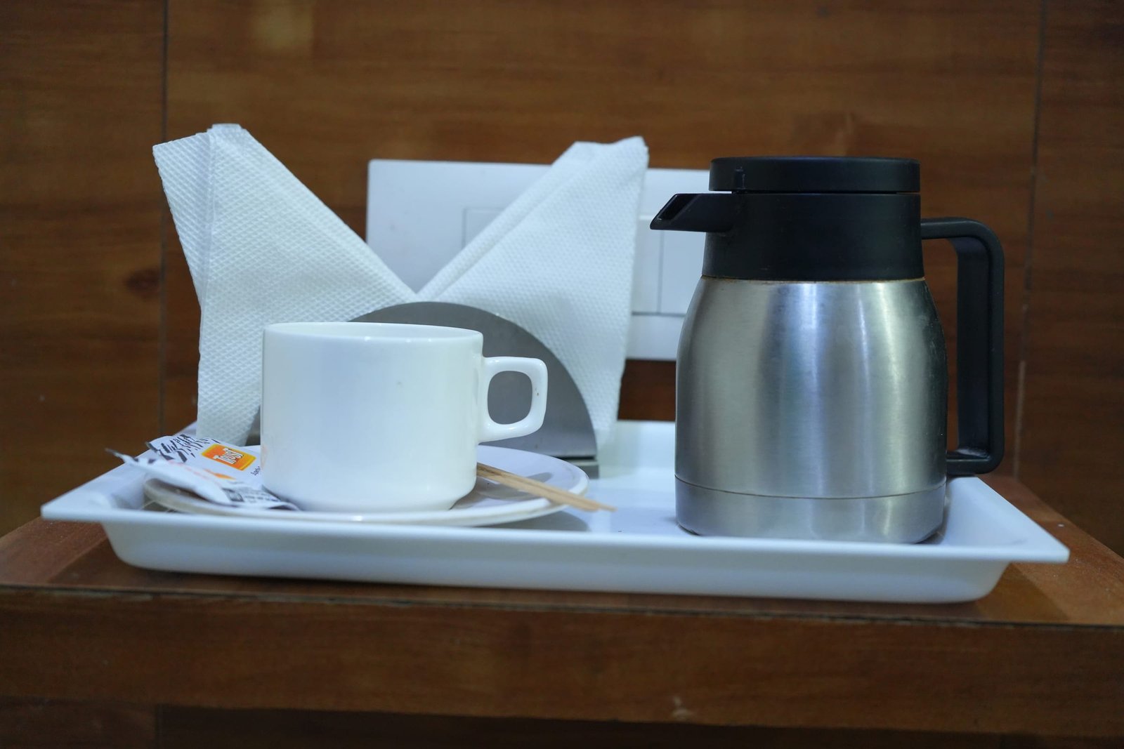 Tea tray with a flask, cups and a folded napkin