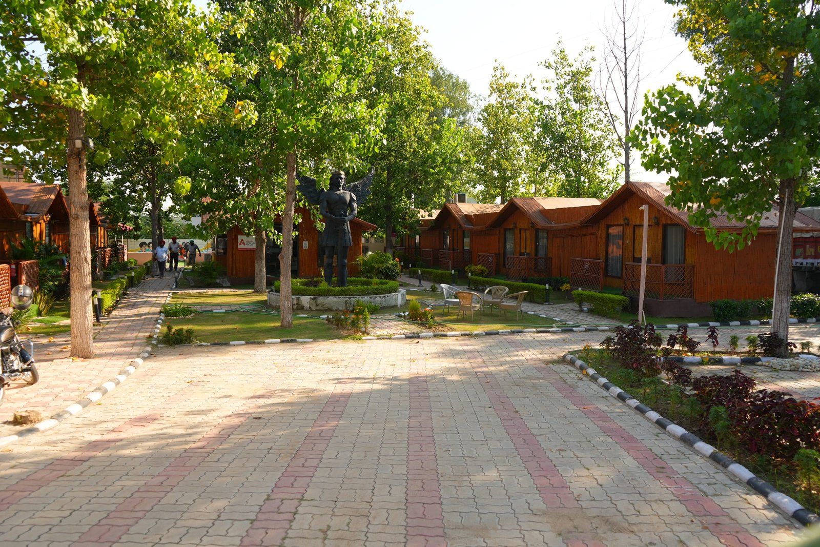 The huts from the far end of the path, under trees