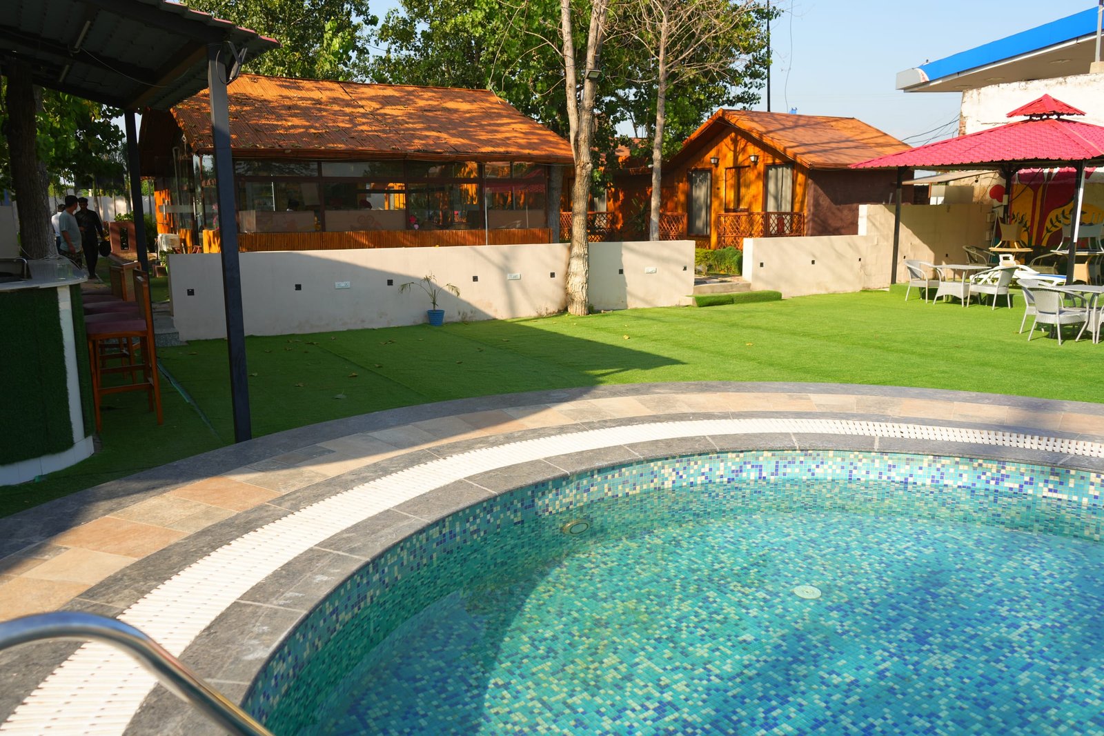The pool and lawn with parasols