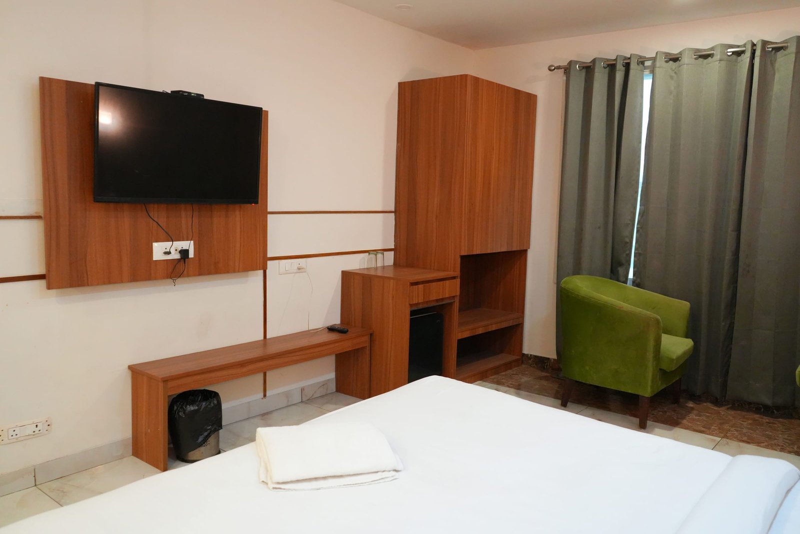 The television and desk unit along the wood-panelled wall