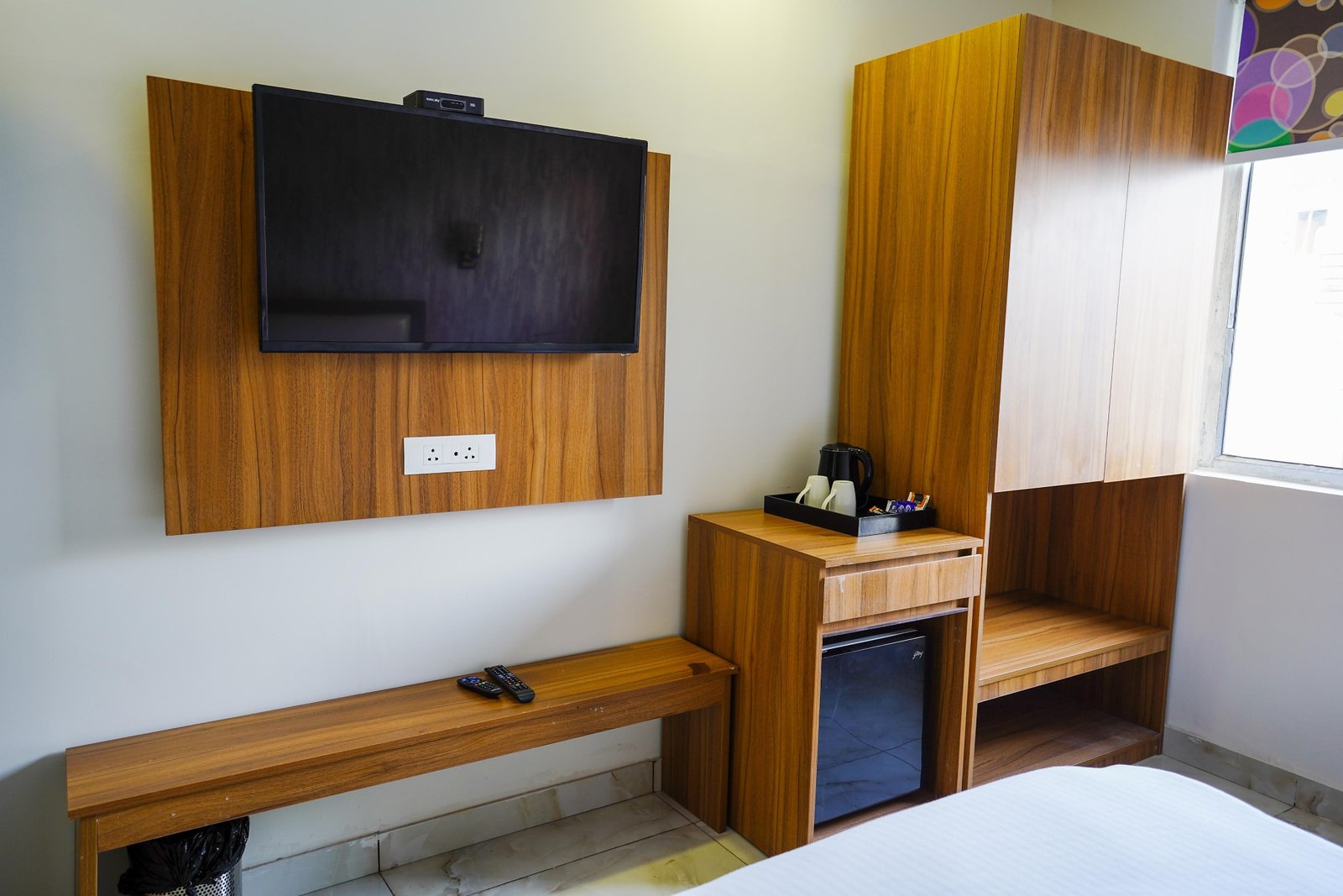 Desk, minibar and television along the room wall