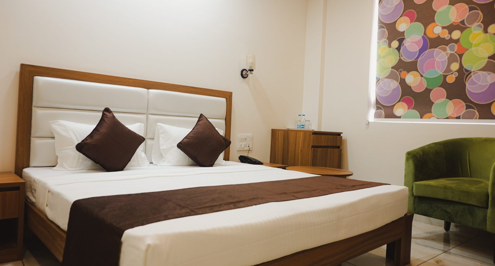 Double room with a bed runner and reading chairs